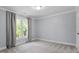 Neutral bedroom with carpet flooring, crown molding, and natural light from a window at 7209 Halstead Ln, Raleigh, NC 27613