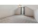 Carpeted bedroom with sloped ceiling and ceiling fan, plus window views and neutral walls at 7209 Halstead Ln, Raleigh, NC 27613