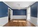 Spacious bedroom with hardwood floors, elegant chandelier, and large windows with natural light at 7209 Halstead Ln, Raleigh, NC 27613