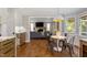 Bright breakfast area open to the living room featuring hardwood floors and natural light at 7209 Halstead Ln, Raleigh, NC 27613