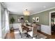 Dining room featuring stylish chandelier, trim detail, and a dining table with seating for six at 7209 Halstead Ln, Raleigh, NC 27613