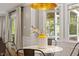 Bright dining area featuring a modern round table, large windows, and access to an outdoor space at 7209 Halstead Ln, Raleigh, NC 27613