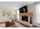Living room showcasing a whitewashed brick fireplace with a wooden mantel and hardwood flooring at 7209 Halstead Ln, Raleigh, NC 27613