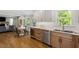 Open kitchen and living area with custom cabinets, granite counters, stainless appliances and hardwood floors at 7209 Halstead Ln, Raleigh, NC 27613