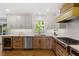Renovated kitchen with granite countertops, updated appliances, and ample storage space at 7209 Halstead Ln, Raleigh, NC 27613