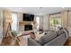 Cozy living room features brick fireplace, hardwood floors, and a comfortable seating arrangement at 7209 Halstead Ln, Raleigh, NC 27613