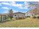 Backyard featuring a wooden deck, a well-manicured lawn, and gray siding on the house at 725 S State St, Raleigh, NC 27601