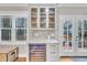 Charming bar area with a wine cooler, glass storage, marble countertop, and french doors to outdoor deck at 725 S State St, Raleigh, NC 27601