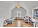 Bright bedroom with hardwood floors, a bed, couch, desk, and a view of outside at 725 S State St, Raleigh, NC 27601