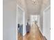 Elegant hallway featuring hardwood floors, neutral walls, and sophisticated lighting leading to the rest of the home at 725 S State St, Raleigh, NC 27601