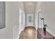 Bright hallway with hardwood floors and neutral tones, complemented by a stylish light fixture and decor at 725 S State St, Raleigh, NC 27601