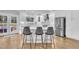 Modern white kitchen with stainless steel appliances and quartz countertops at 725 S State St, Raleigh, NC 27601