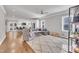 Open-concept living area showcasing hardwood floors, neutral decor, and seamless flow to the kitchen and dining space at 725 S State St, Raleigh, NC 27601