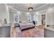 Primary bedroom suite featuring trey ceilings, hardwood floors, and an ensuite bathroom providing comfort and style at 725 S State St, Raleigh, NC 27601