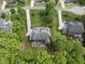 Well-manicured backyard with an outdoor patio set and surrounding trees at 7517 Summer Pines Way, Wake Forest, NC 27587