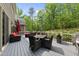 Large deck with a dining table, chairs, and outdoor kitchen perfect for entertaining at 7517 Summer Pines Way, Wake Forest, NC 27587