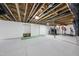 Unfinished basement space with golf simulator and putting green, offering recreation at 7517 Summer Pines Way, Wake Forest, NC 27587