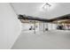 Unfinished basement with high ceilings, painted walls, and ample space for storage or recreation at 7517 Summer Pines Way, Wake Forest, NC 27587