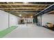 Finished basement with golf simulator, gym and painted white walls at 7517 Summer Pines Way, Wake Forest, NC 27587