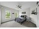 Cozy bedroom with two windows, neutral gray carpet and a modern bedframe with views of the neighborhood at 7517 Summer Pines Way, Wake Forest, NC 27587