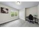 Neutral toned bedroom with a large window, closet, and space for a desk and chair at 7517 Summer Pines Way, Wake Forest, NC 27587