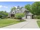 Two-story home with a well-manicured lawn, a long driveway, and a detached garage at 7517 Summer Pines Way, Wake Forest, NC 27587