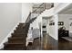 Spacious foyer with dark wood floors, a staircase, and a view into the living area at 7517 Summer Pines Way, Wake Forest, NC 27587