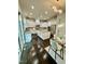 Bright modern kitchen featuring white cabinets, granite countertops, stainless steel appliances, and hardwood floors at 7517 Summer Pines Way, Wake Forest, NC 27587