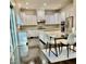 Bright modern kitchen featuring white cabinets, granite countertops, stainless steel appliances, and hardwood floors at 7517 Summer Pines Way, Wake Forest, NC 27587