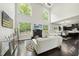 Bright living room featuring soaring ceilings, large windows, a fireplace, and modern furnishings at 7517 Summer Pines Way, Wake Forest, NC 27587