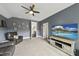 Spacious living room area features plush leather seating, large TV and neutral carpet in a naturally lit room at 7517 Summer Pines Way, Wake Forest, NC 27587
