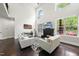 Bright living room with high ceilings, large windows, a fireplace, and contemporary furniture at 7517 Summer Pines Way, Wake Forest, NC 27587