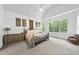 Large main bedroom with vaulted ceilings, neutral carpet, and beautiful natural light from large windows at 7517 Summer Pines Way, Wake Forest, NC 27587