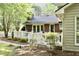 Charming brick home featuring a spacious backyard deck and lush landscaping at 775 Sid Eaves Rd, Youngsville, NC 27596
