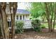 Outdoor deck surrounded by lush greenery, creating a private and serene atmosphere at 775 Sid Eaves Rd, Youngsville, NC 27596