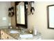Stylish bathroom featuring granite countertop, vanity lighting, and a decorative mirror at 775 Sid Eaves Rd, Youngsville, NC 27596