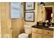 Well-lit powder room featuring a toilet, vanity with storage space, and decor at 775 Sid Eaves Rd, Youngsville, NC 27596