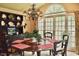 Bright dining area with a round table, large window, floral curtains and chandelier at 775 Sid Eaves Rd, Youngsville, NC 27596