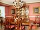 Formal dining room with a large wooden table, china cabinet, and elegant decor at 775 Sid Eaves Rd, Youngsville, NC 27596