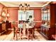 Elegant dining room featuring a wood table, chairs, chandelier, china cabinet, and a decorative rug at 775 Sid Eaves Rd, Youngsville, NC 27596