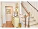 Inviting foyer with staircase, decorative chest, and elegant decor at 775 Sid Eaves Rd, Youngsville, NC 27596