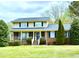 Charming two-story home with a brick facade and a welcoming covered front porch at 775 Sid Eaves Rd, Youngsville, NC 27596