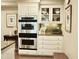 Well-equipped kitchen featuring built-in oven, granite countertops, and white cabinets at 775 Sid Eaves Rd, Youngsville, NC 27596