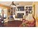 Cozy living room with fireplace, custom built-ins, and ceiling fan for year-round comfort at 775 Sid Eaves Rd, Youngsville, NC 27596
