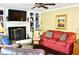 Comfortable living room featuring a fireplace, built-in shelving, and plenty of seating at 775 Sid Eaves Rd, Youngsville, NC 27596