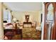 Cozy living room with large windows, a comfortable sofa, and traditional furnishings at 775 Sid Eaves Rd, Youngsville, NC 27596