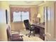 Traditional home office with a wooden desk, office chair, and window with decorative valance at 775 Sid Eaves Rd, Youngsville, NC 27596