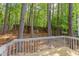 Backyard view from deck overlooking trees, lush foliage, and fenced yard at 8124 Greywinds Dr, Raleigh, NC 27615