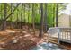 Landscaped backyard featuring a wooden treehouse, stone walkway, and a charming patio at 8124 Greywinds Dr, Raleigh, NC 27615
