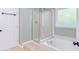 Bright bathroom features a shower with glass enclosure, and a soaking tub next to a window at 8124 Greywinds Dr, Raleigh, NC 27615